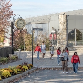 Students walking on campus and talking about potentially changing majors 
