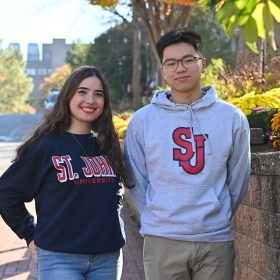 Two St. John's University transfer students standing and smiling 