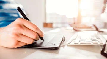 Person's hand working from home