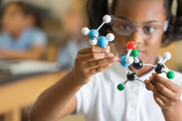 Girl holding science tool model