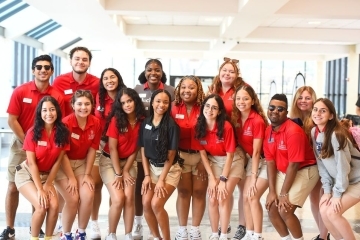 Group of students all in red polos posing for photo