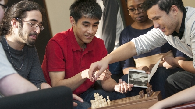 Group of students sitting around a table working together