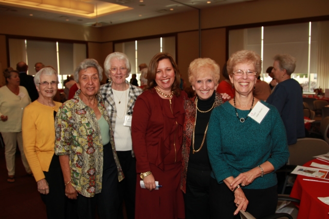 Group of woman standing as they pose for photo