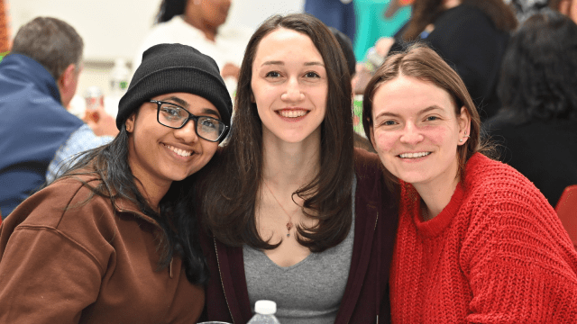 Three students at the Public Interest Auction.