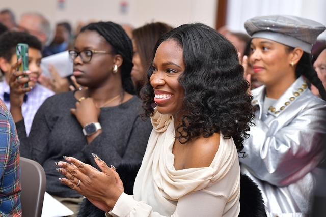 Guests clapping in the audience at the Induction Ceremony of Cassandra A. Johnson ’03C, ’06L