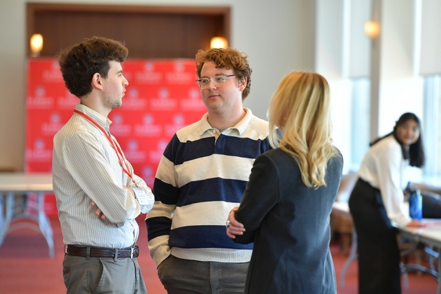 Students chatting near check-in table