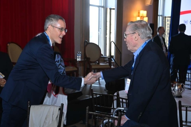 Two guests at the BIGEAST Summit shaking hands