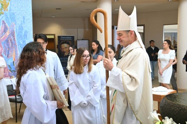 Bishop Brennan walking into St. Thomas More Church