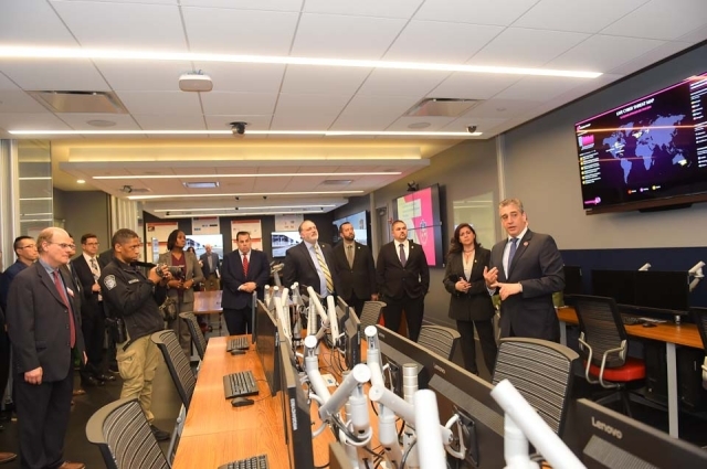 People gathered around row of computers in cyber security lab